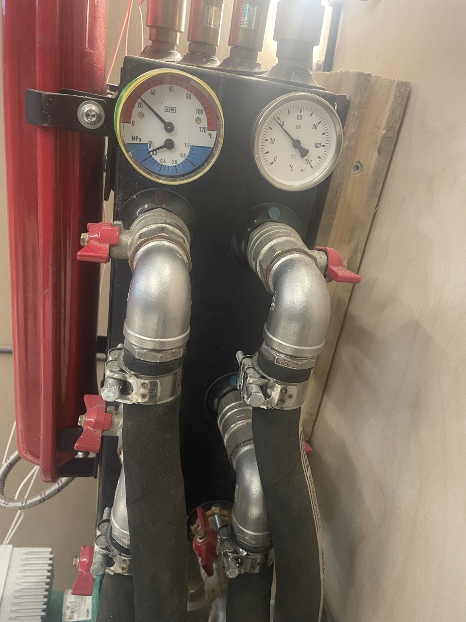 Heating manifold tying miner heat into the building water loop