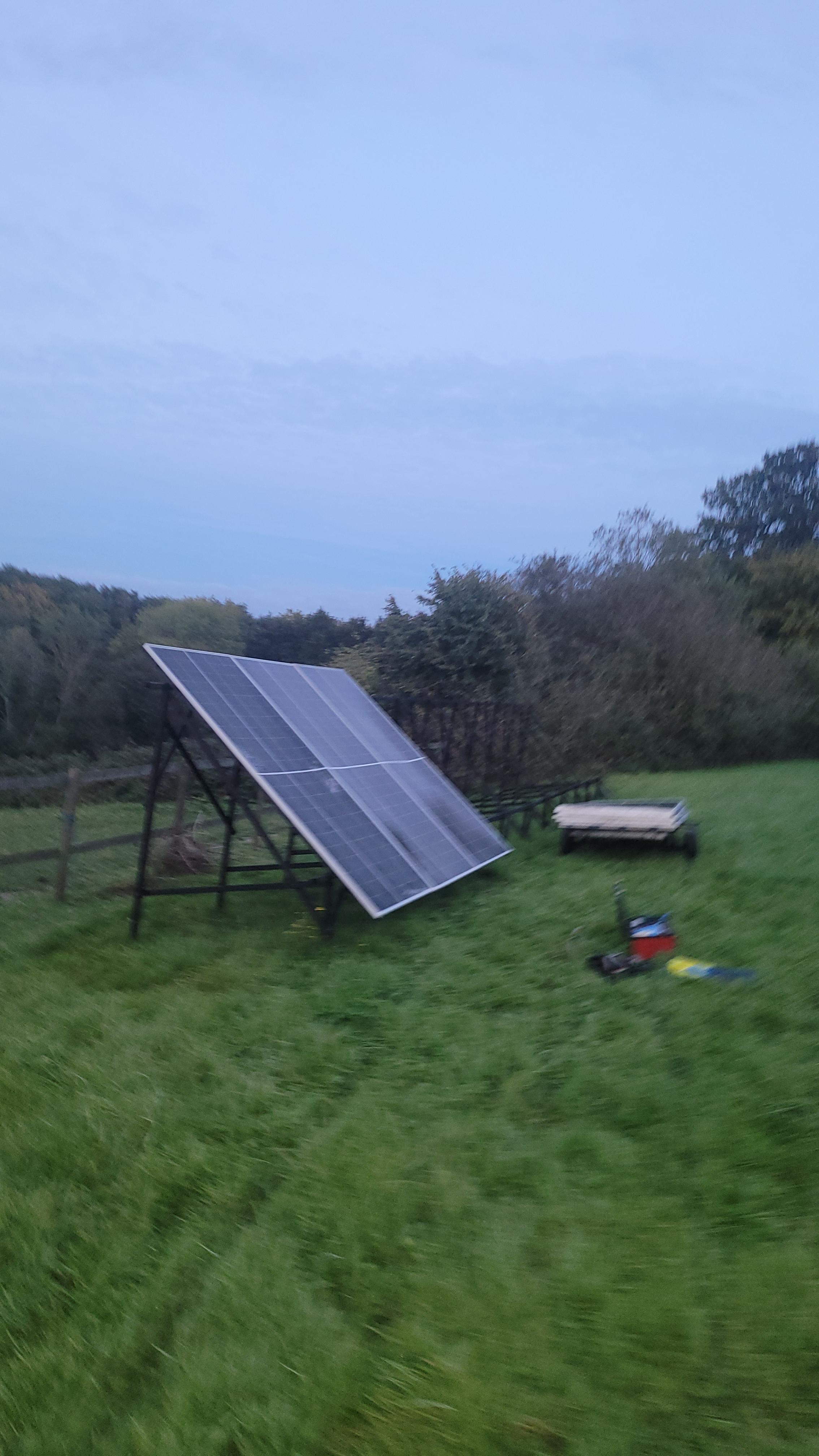 The off-grid solar array in a UK field at dusk